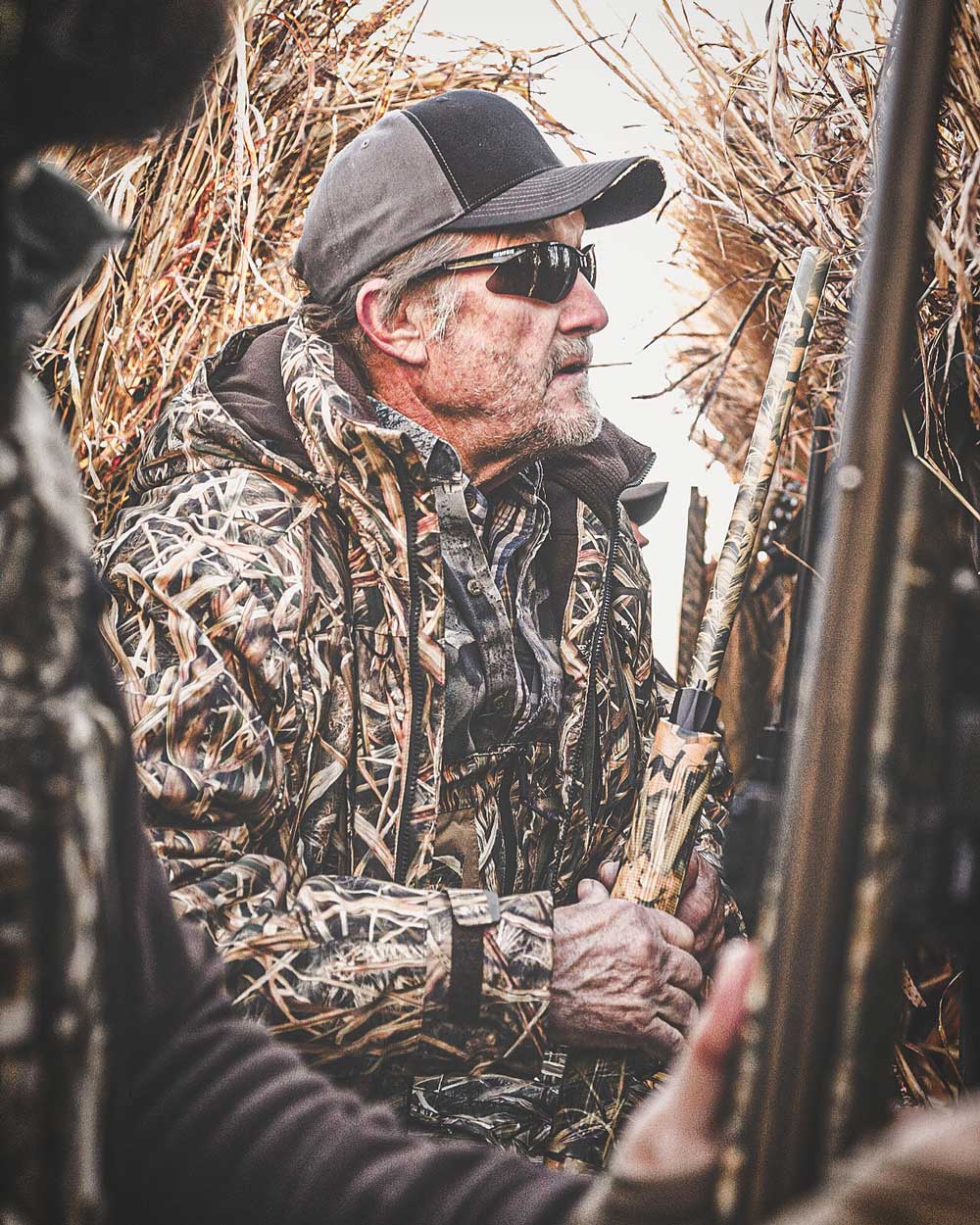 Man wearing camo sitting in hunting blind