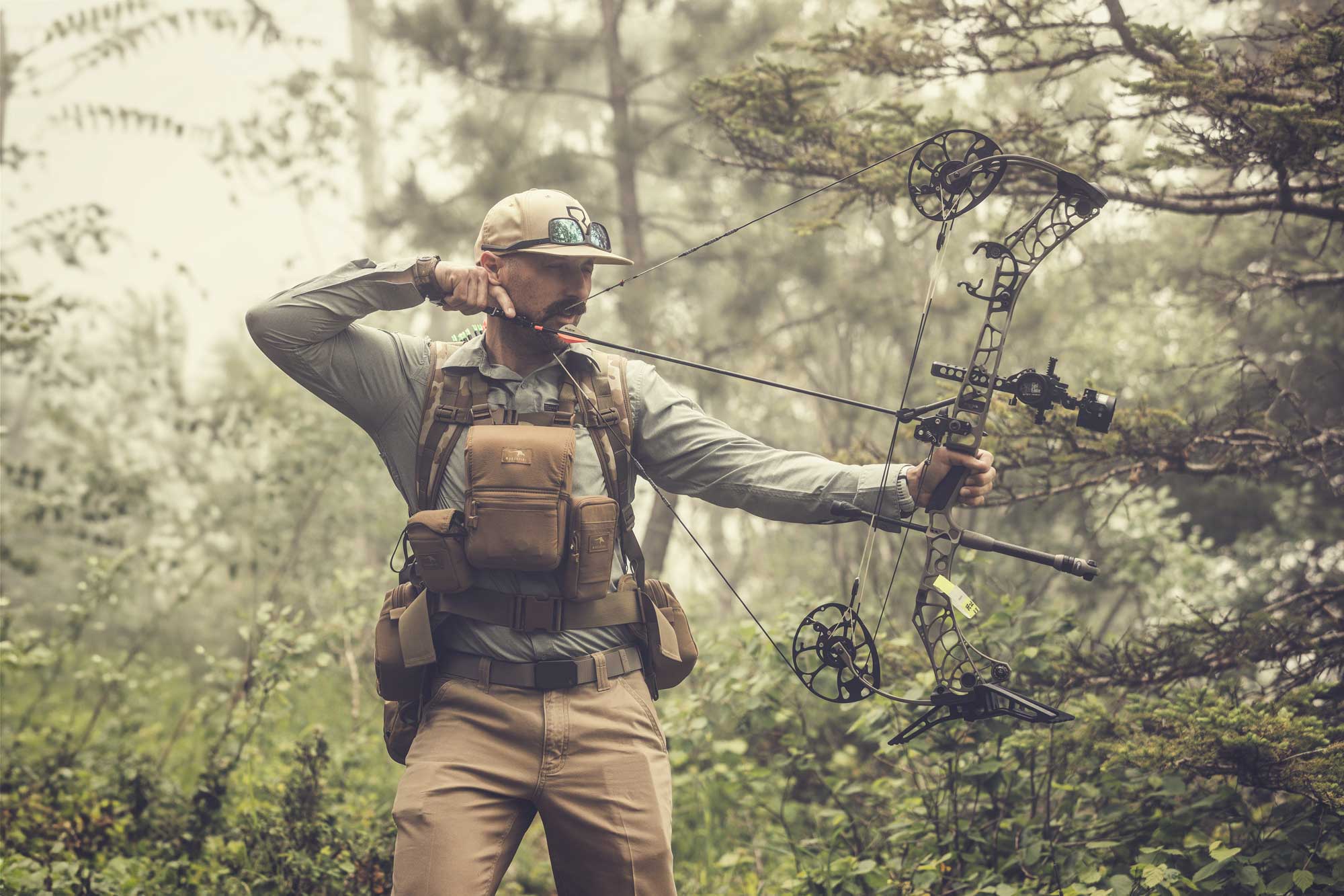 Man hunting with bow and arrow - Timeless Outdoors - Men's Outdoors Lifestyle Apparel
