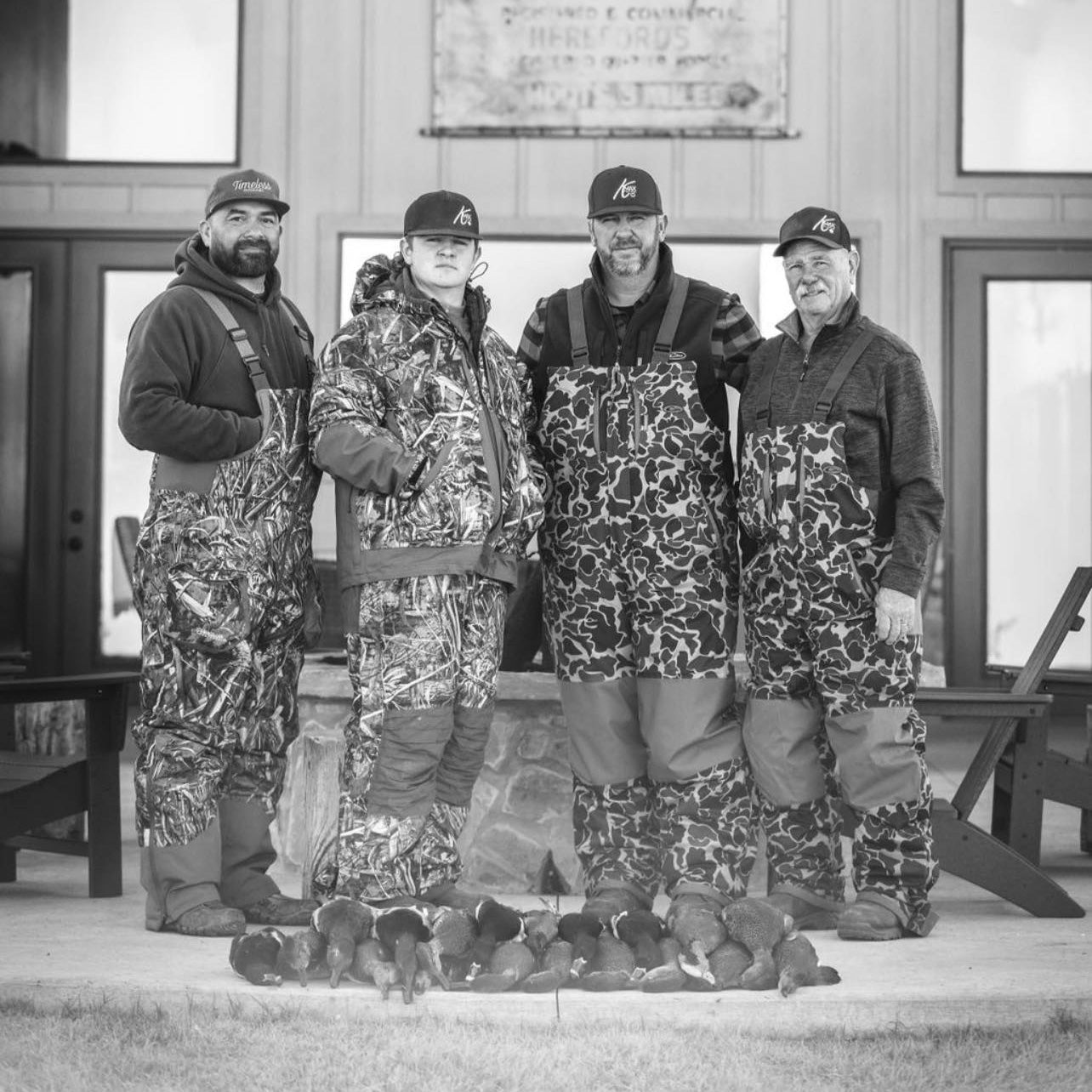group of four hunters posing with their ducks